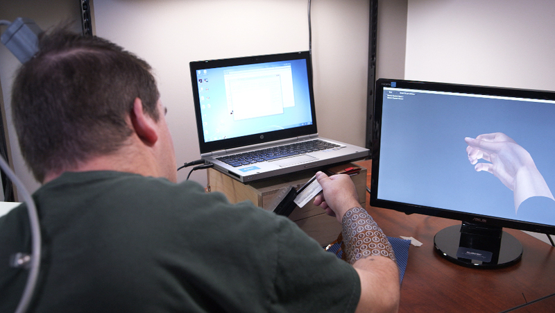 Ian Burhkart swiping a credit card. Image: Ohio State University/ Batelle